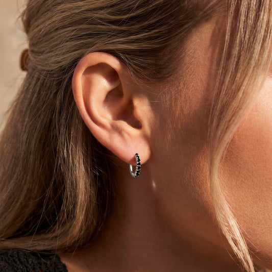 Model wearing the black onyx queen bonny hoop earring