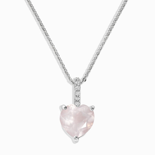 Rose quartz necklace worn against a neutral top