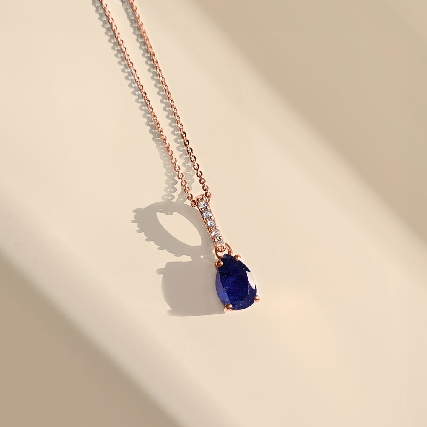 Blue Sapphire Necklace Sway - rose gold flat lay