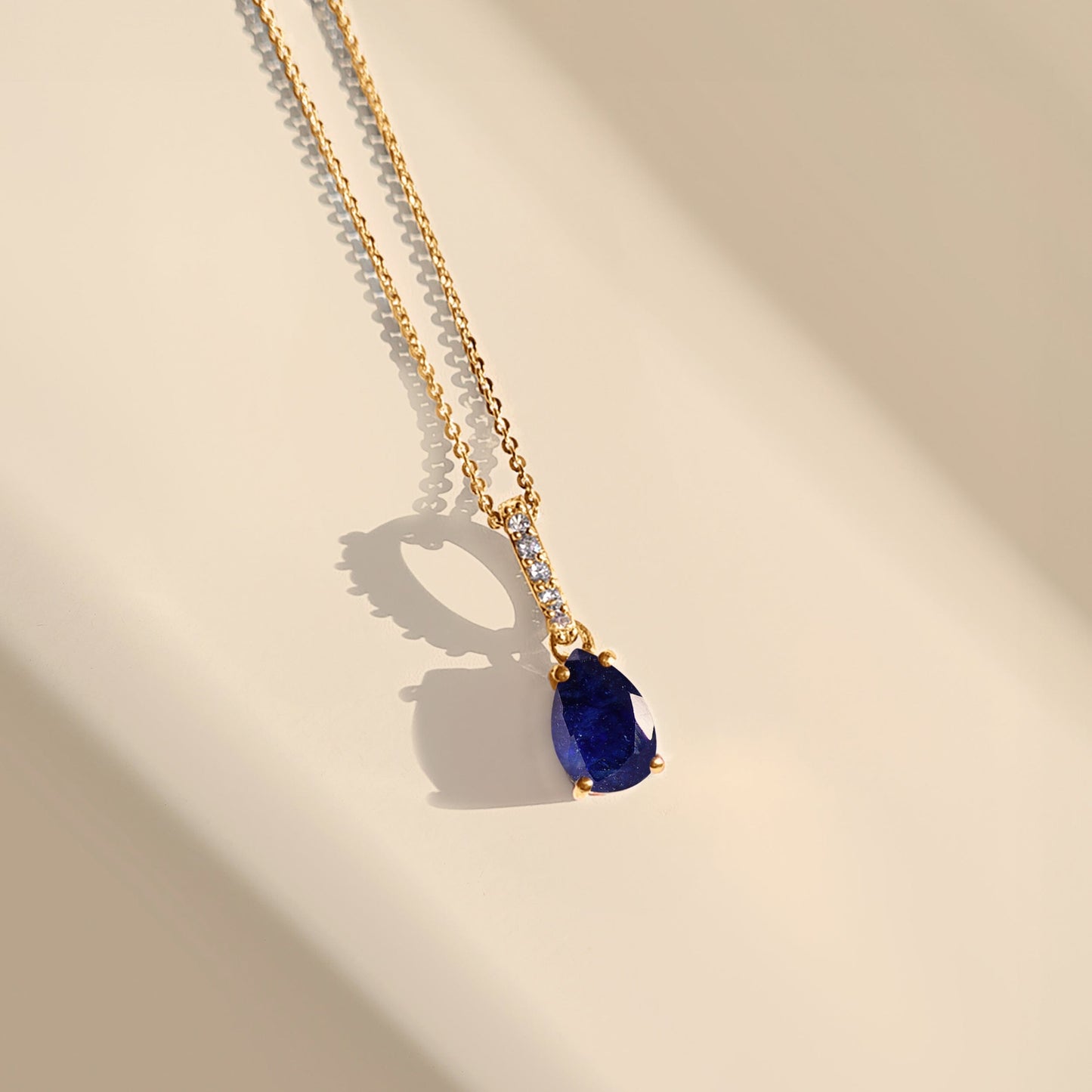 Blue Sapphire Necklace Sway - yellow gold flat lay