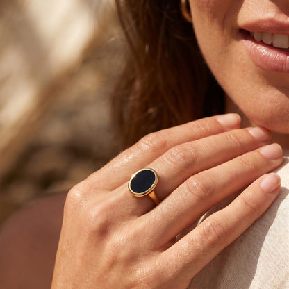 Black Onyx Ring Enfolded yellow gold on hand