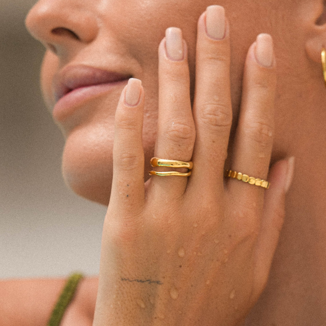 Gemini gold rings on model hand