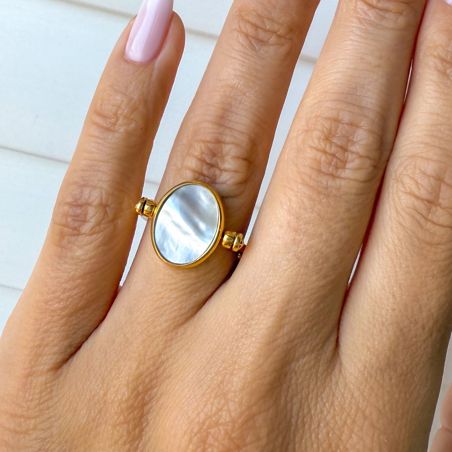 Black Onyx Mother of Pearl Fidget Ring - yellow gold on hand