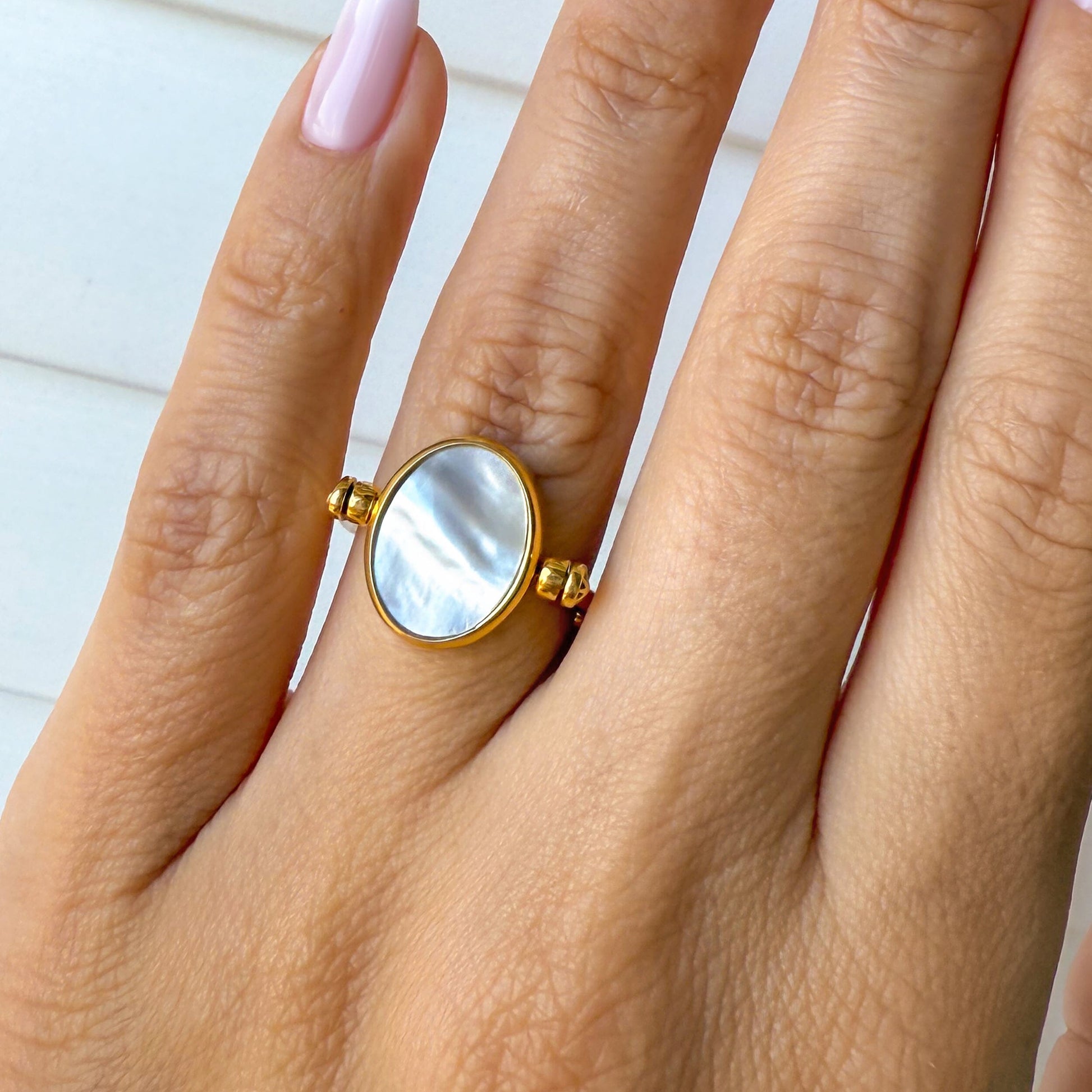 Black Onyx Mother of Pearl Fidget Ring - yellow gold on hand