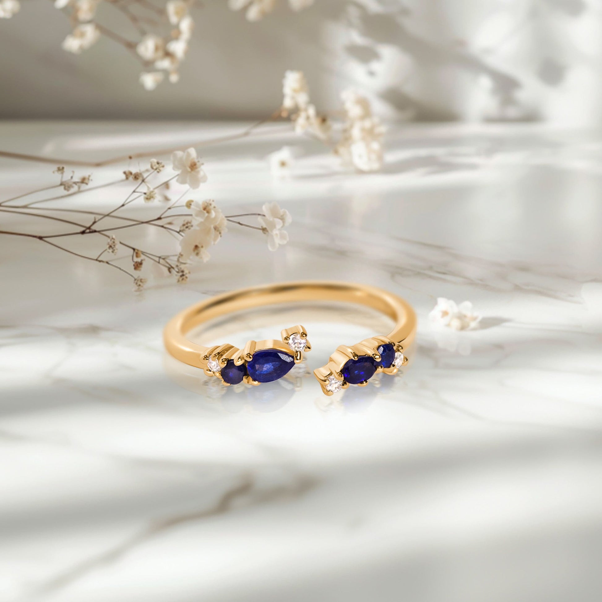 Adjustable Blue Sapphire Ring Flourish - yellow gold on marble