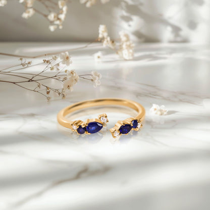 Adjustable Blue Sapphire Ring Flourish - yellow gold on marble