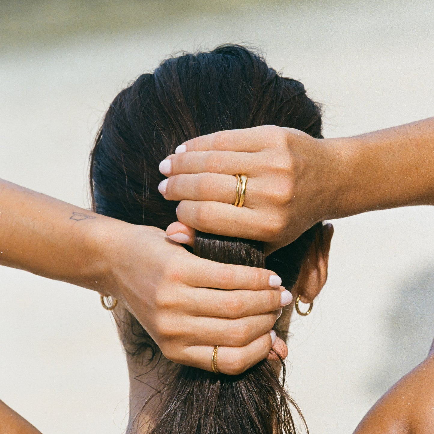 Gemini gold rings detail on hand