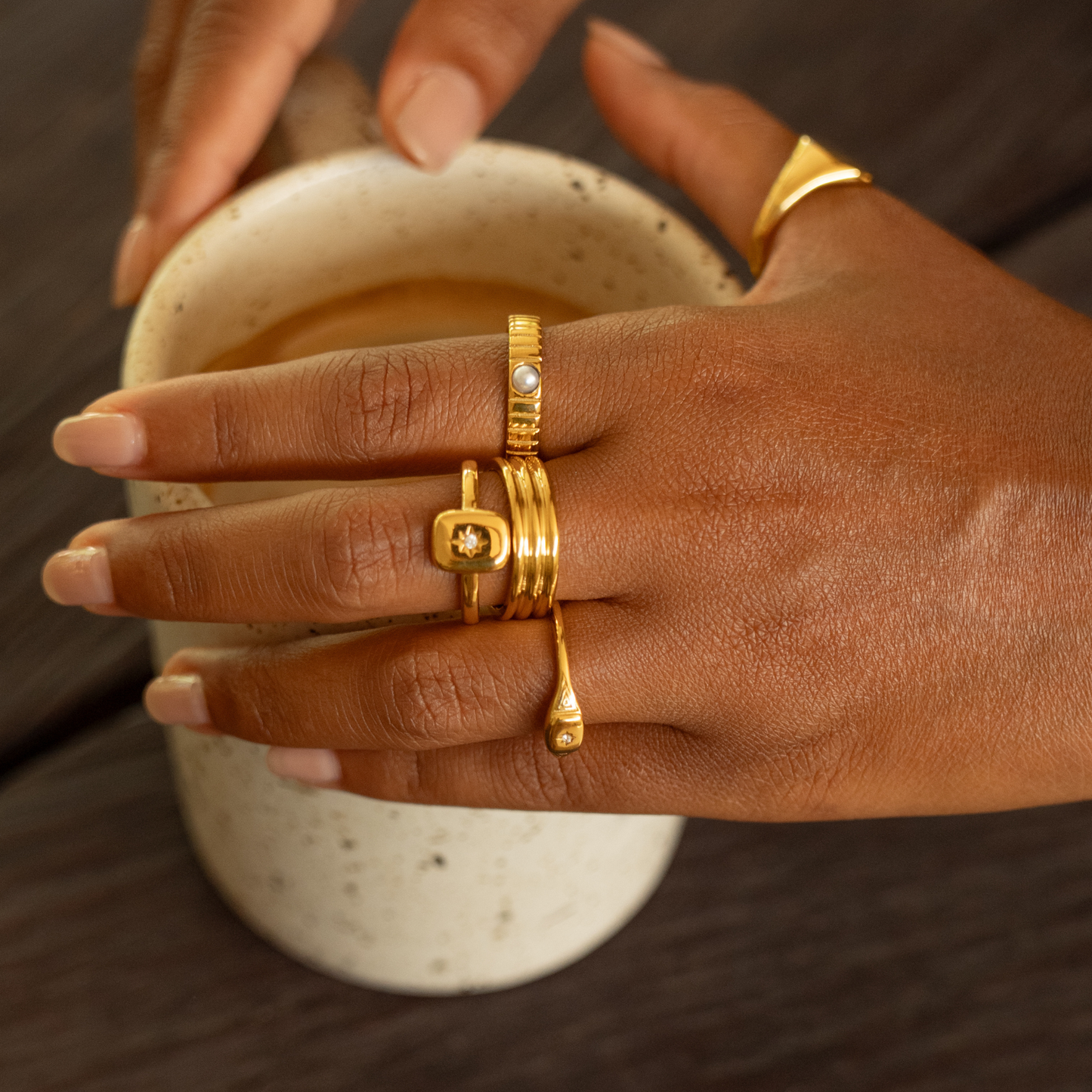 Gold star signet on hand
