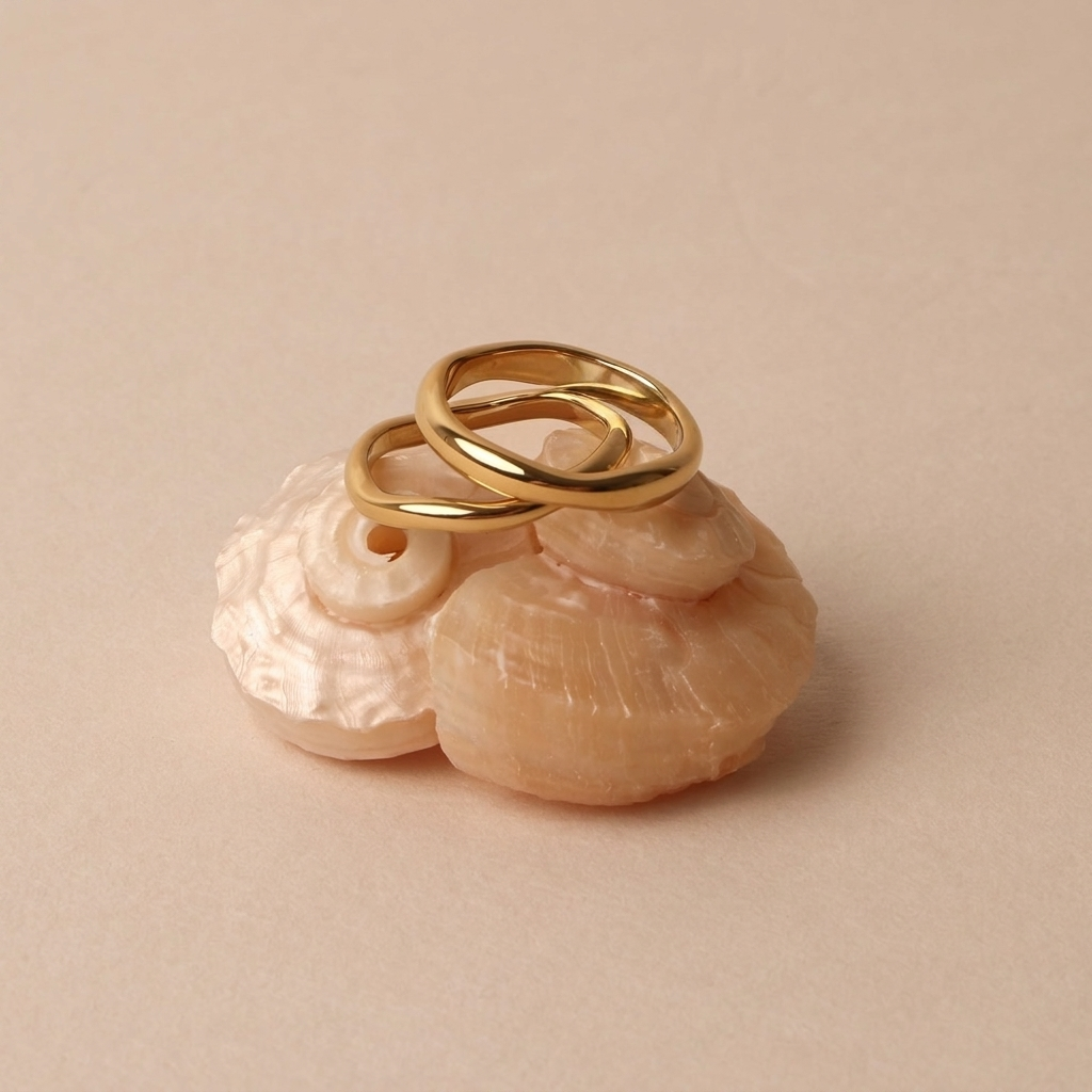 Gemini gold rings on seashell