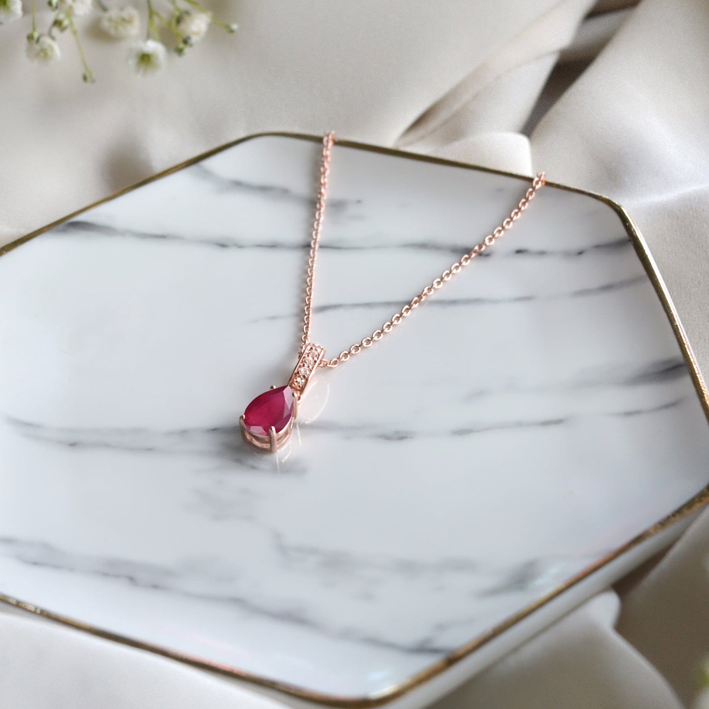 Ruby Necklace Sway - July Birthstone - rose gold flat lay