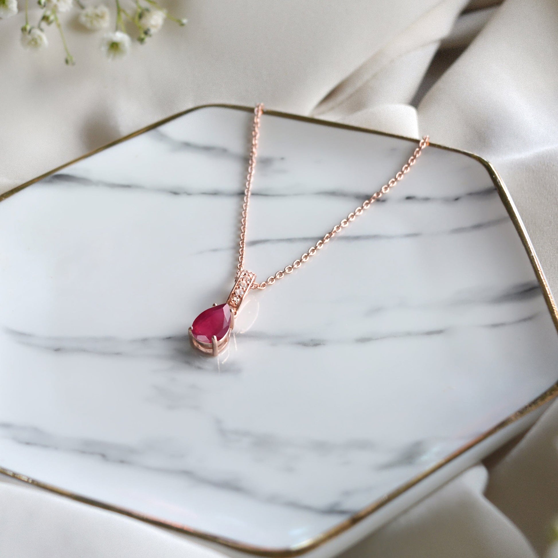 Ruby Necklace Sway - July Birthstone - rose gold flat lay