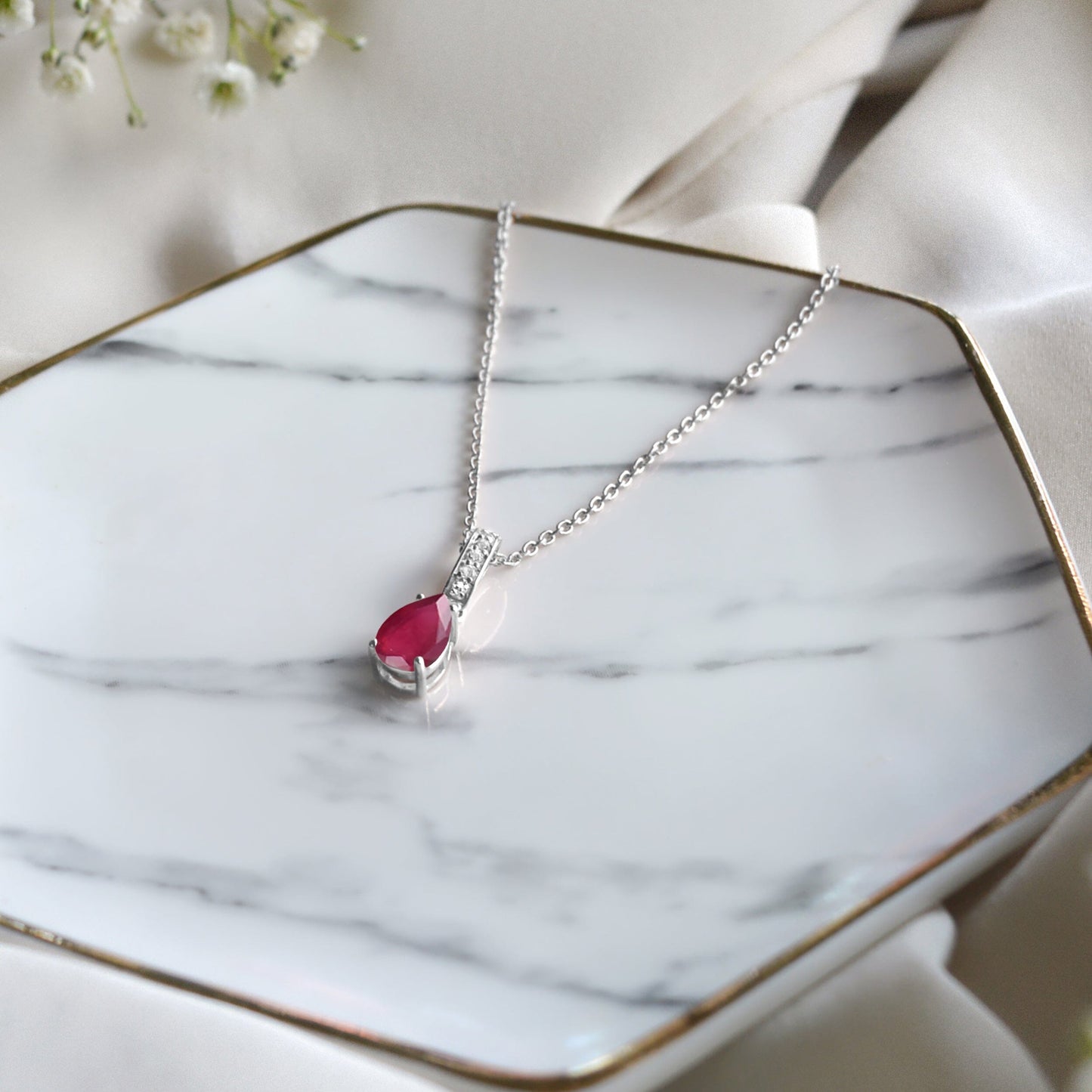 Ruby Necklace Sway - July Birthstone - silver flat lay